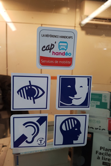Le logo « Cap’Handéo Services de mobilité » et les quatre logos des différents handicaps affichés dans une station de métro de la ligne 1
